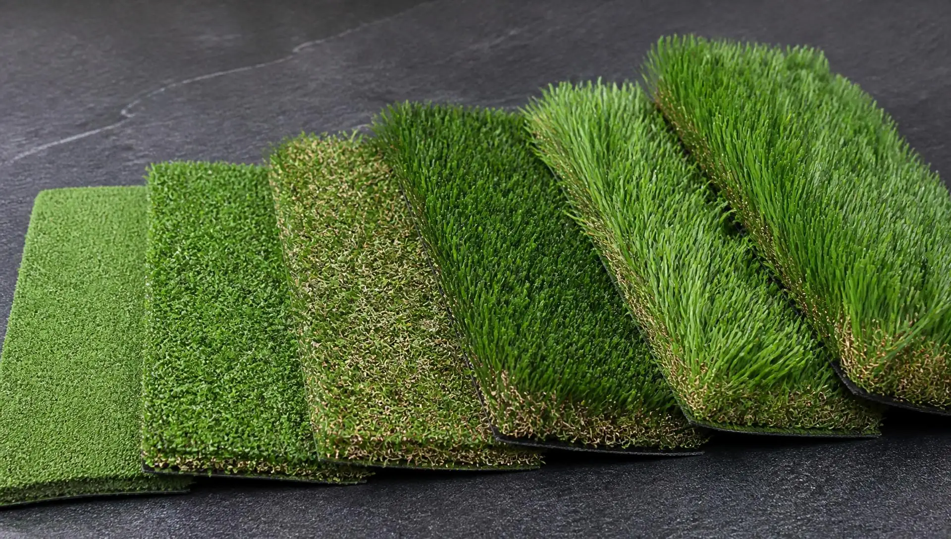 Artificial turf sample swatches angled side by side showing different pile heights and textures.